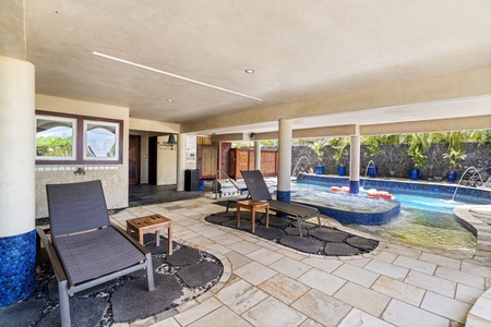 Shaded poolside lounge with chaise chairs and easy spa access—perfect for sunbathing or afternoon naps.