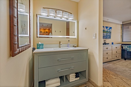 The guest bathroom at Royal Kahana 610 offers a sleek, modern vanity with ample counter space and storage for your convenience.