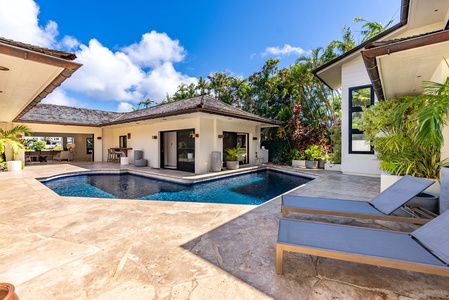 Sit poolside and breathe in fresh air surrounded by lush landscaping and clean island architecture.