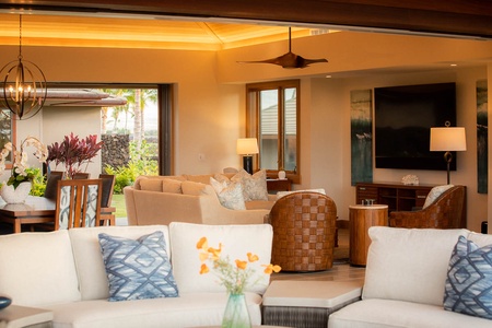 Wind down after beach days in this breezy, modern living area with rich wood ceilings and calming tones.