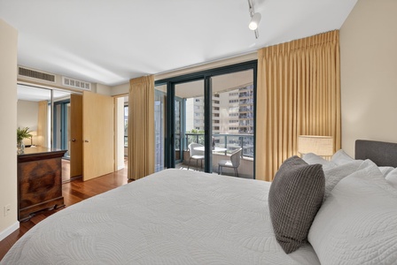 Retreat to this peaceful bedroom with floor-to-ceiling windows and private lanai access.