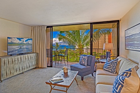 Relax in the comfortable living room, complete with a view of the palm trees and ocean just beyond the lanai