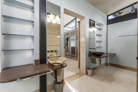 A luxurious bathroom with a skylight, rainfall shower, and modern design.