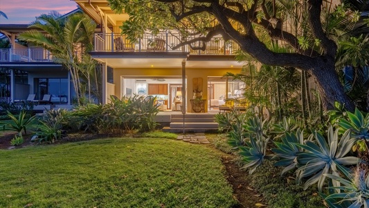 Ground-level lanai opens to a lush green yard—perfect for relaxing.