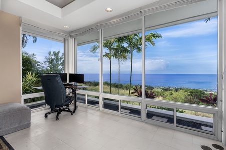 Your inspiring workspace awaits with panoramic ocean views through floor-to-ceiling windows, where tropical palm trees frame endless blue horizons.