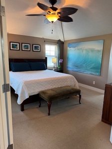 Primary bedroom with a king-size bed and calming decor.