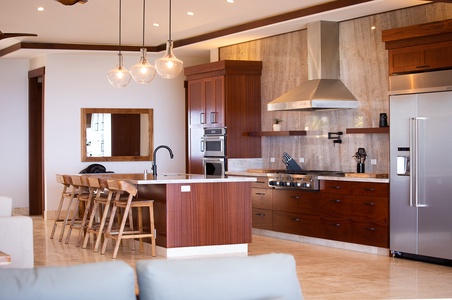 Prepare gourmet meals in a fully equipped kitchen with a six-burner cooktop and sleek finishes.