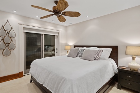 The downstairs guest bedroom features a king-sized bed and lanai.