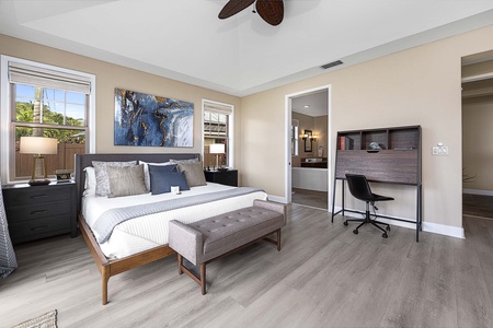 Additional guest suite with a king bed, ceiling fan, workspace, and ensuite bathroom for ultimate comfort.