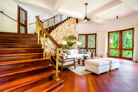 Cozy living room with a beautiful wooden staircase.