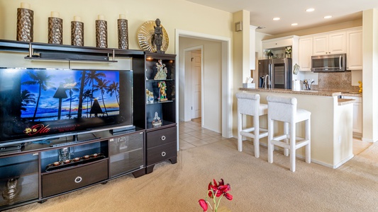 There's a large TV for game night and breakfast bar seating at the kitchen area.