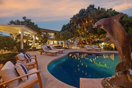 Relax by the pool at twilight, a peaceful spot to enjoy a drink.