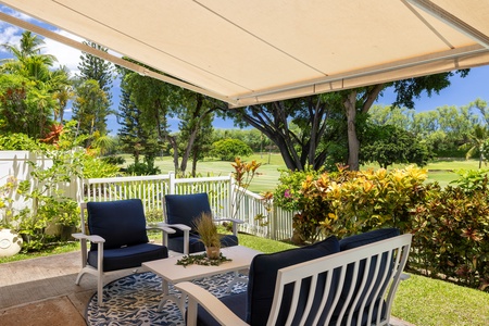 Seating on the lanai surrounded by lush greenery.