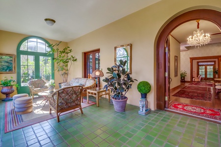 Enter the home through the sunroom, a second living area providing a bright and airy space to relax and unwind.