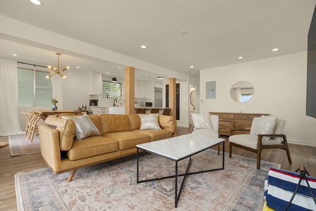 Living area featuring a comfortable leather sofa and a large coffee table.