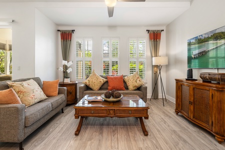 Plenty of seating and natural lighting in this seamless living and kitchen area.