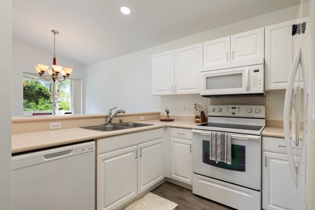 Your fully-equipped kitchen awaits with crisp white cabinets, stainless appliances, and everything you need to create memorable meals together.