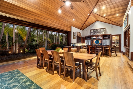 Gather around this stunning dining space where warm wood meets tropical views, perfect for memorable meals together.