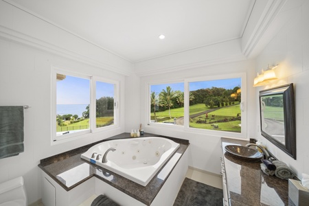 Relax on the ensuite bathroom with a large tub and expansive windows.