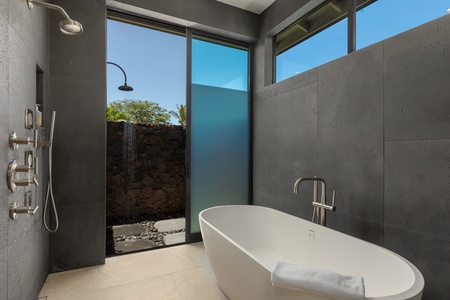 Immerse yourself in luxury in this exquisite bathroom, designed with a standalone bathtub and an open-air shower.