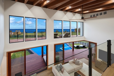 Enjoy the ocean views from the spacious living area, with floor-to-ceiling windows and easy access to the outdoor pool and lanai.
