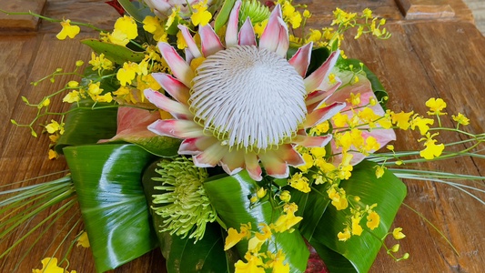 Vibrant floral centerpiece brings a burst of Big Island color and native botanical beauty into your living space.