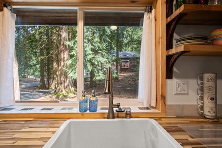 Enjoy forest views from the kitchen sink as you rinse produce or prep meals—it’s cooking with a view.