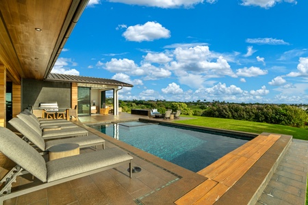 Modern pool terrace offers pristine swimming with expansive views over lush landscapes and rolling countryside.