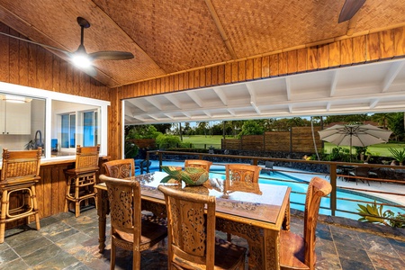 A dining table for six sits open to the pool, dinner and a swim a few steps apart.