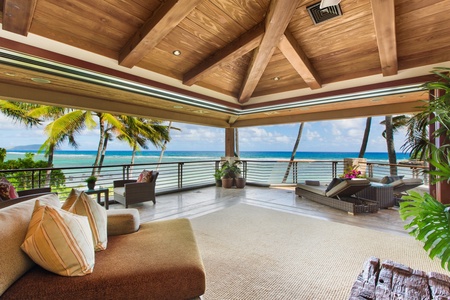 The primary suite opens to sweeping ocean views and breezy outdoor living spaces designed for relaxation.