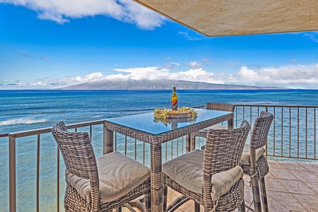 The spacious lanai offers stunning ocean views, perfect for lounging or dining outdoors.