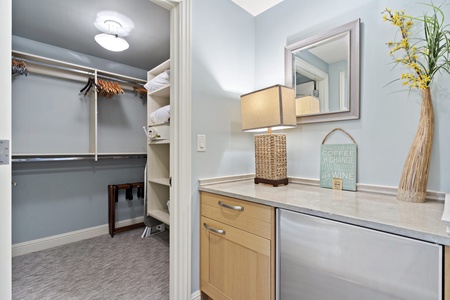 Discover streamlined convenience in this chic vanity space, with a walk-in closet for a tidy stay.