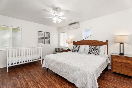 Drift into restful sleep in your spacious bedroom with quality linens, while baby sleeps peacefully nearby in the provided crib.