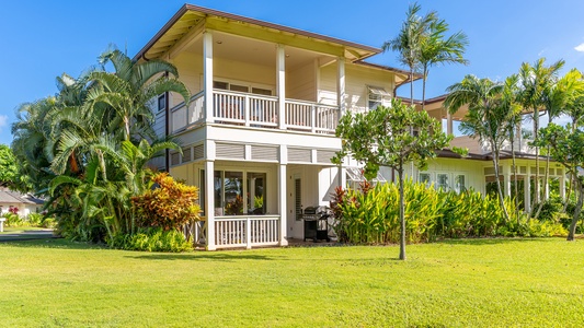 The beautiful condo with manicured landscaping under swaying palm trees.