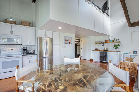 Newly remodeled kitchen with custom cabinetry, updated appliances, and open shelving.