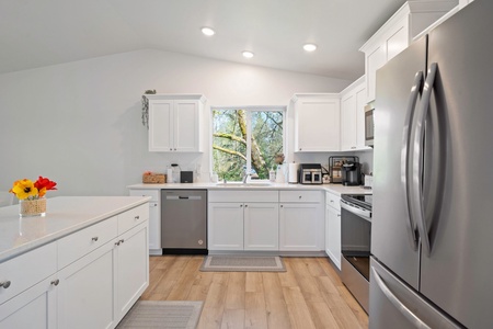 Let the natural light pour in as you prepare lakeside snacks or family dinners in this well-appointed culinary space.