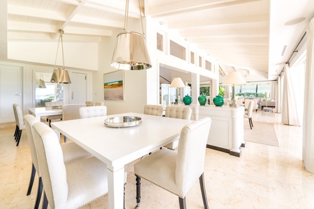 Dine in style in the elegant dining area, featuring chic white furniture and a bright, airy ambiance.