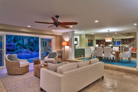 Views from the front door of the sitting room, pool deck with waterfall, dining room and further is the kitchen.