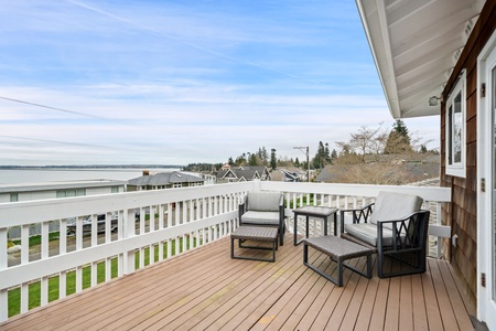 Sip your morning coffee on this stunning deck while enjoying panoramic water views and coastal charm.