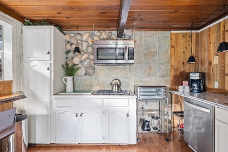 Cook your favorite meals in the kitchen with rustic charm and modern amenities.