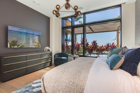Wake up in your luxurious bedroom with stunning garden views and modern tropical elegance surrounding you.