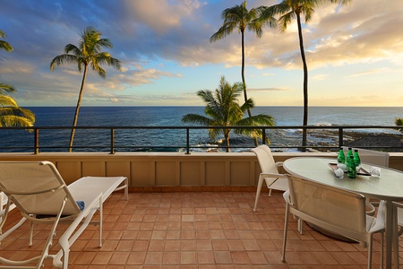 Unwind on the oceanfront lanai with seating for four and two lounge chairs—perfect for sunset views and relaxing by the waves.