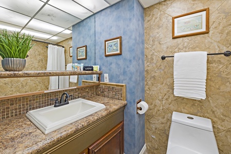 The bathroom at Kaanapali Shores 544 features a granite vanity and ample lighting for relaxation.