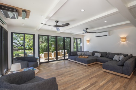 Spacious Living Room with floor to ceiling glass sliders for seamless connection.