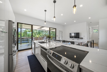 This open-concept kitchen is perfect for cooking and entertaining, featuring sleek modern appliances and a spacious island.