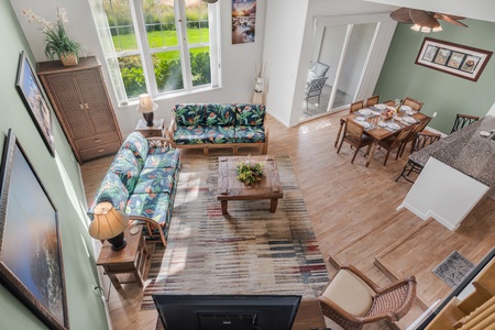 Island-inspired furnishings and flowing architecture connect the kitchen, dining, and living spaces for effortless vacation living.
