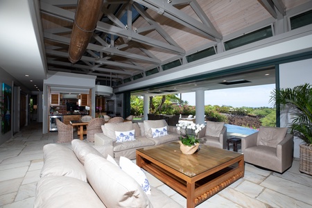 Indoor-outdoor living flows effortlessly with plenty of cozy seating and tropical views.