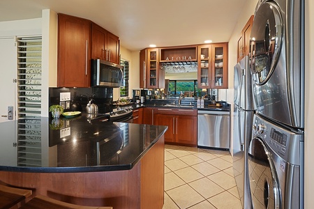 The kitchen has wide counter spaces and stainless steel appliances with an in-unit washer and dryer.