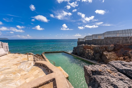 Gather around this elegant dining table where stunning ocean views frame every meal you'll share together.