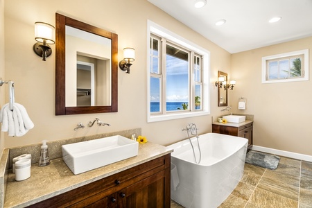 Elegant primary bathroom with dual vanities for added comfort.